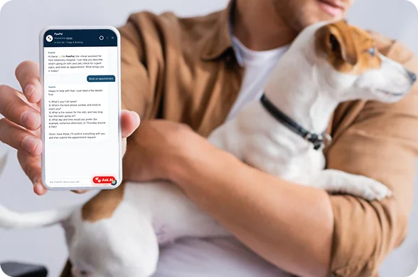how-work-1 how-work-1 Person holding a smartphone with a chat app open, while cradling a small dog in their arm.